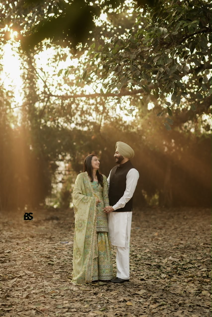 Couple smiling together in warm forest light