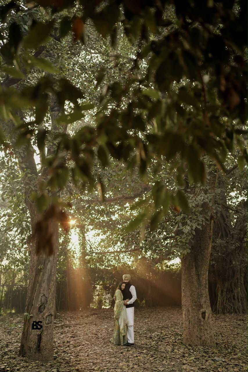 Wide cinematic woodland portrait of a couple embracing