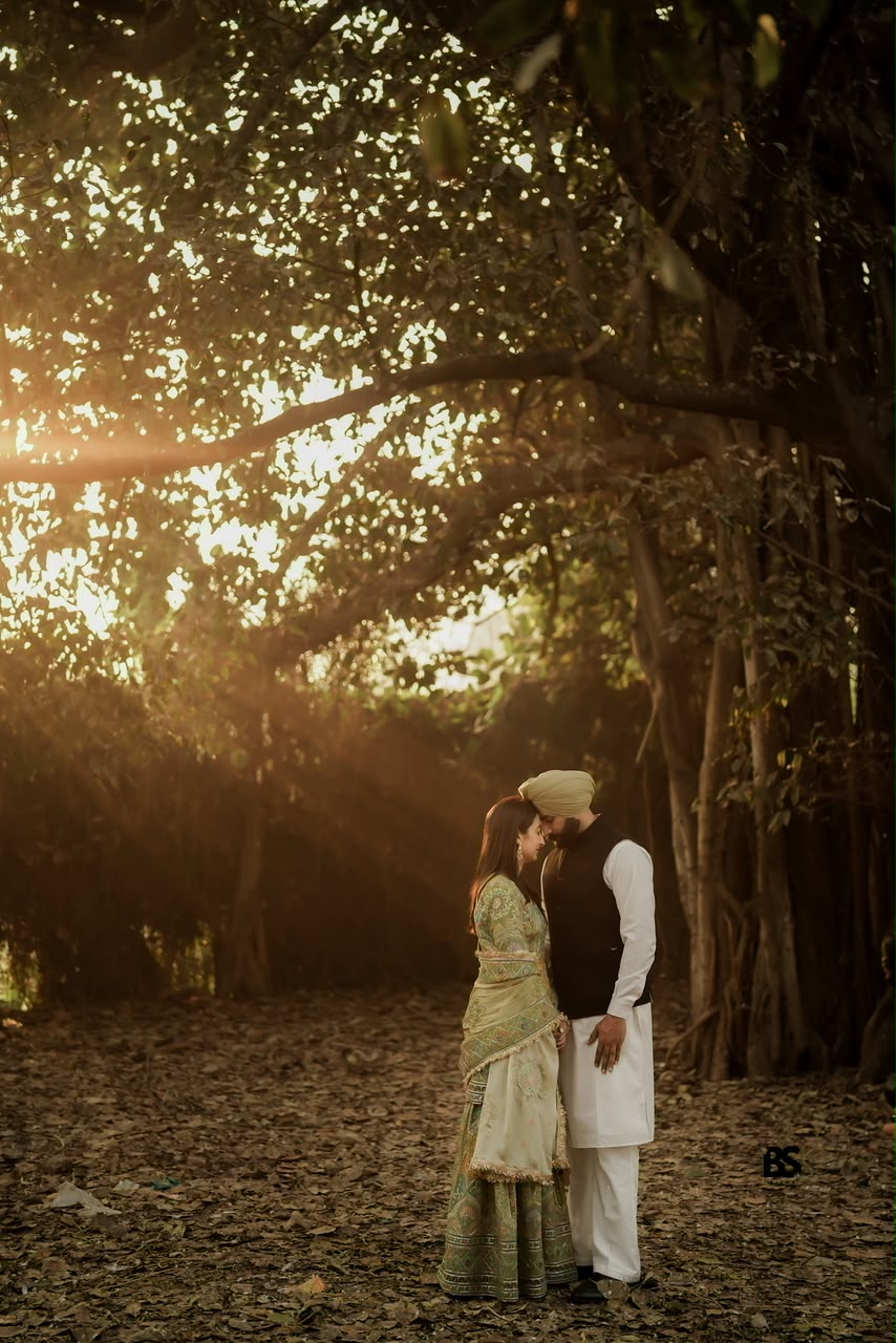 Couple sharing a quiet moment beneath golden trees