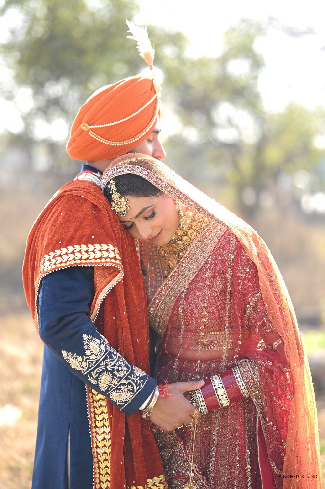 Punjabi bride and groom sharing a quiet embrace