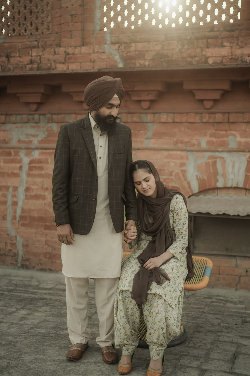 Couple holding hands before a historic brick wall