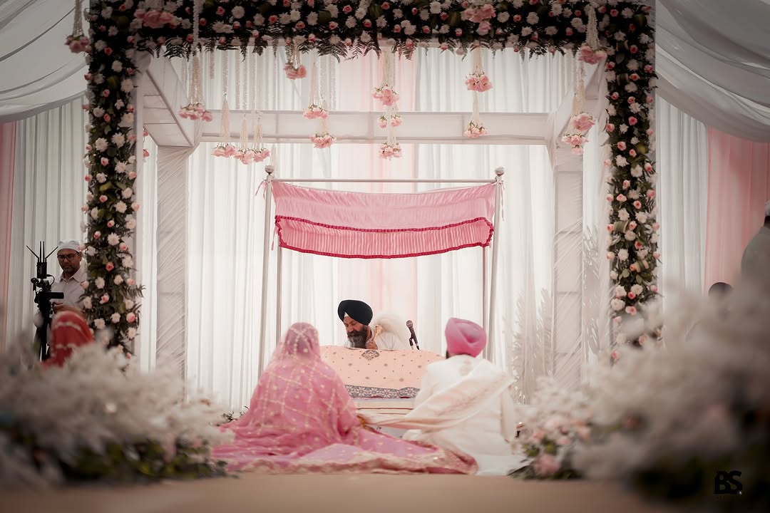 Sikh wedding ceremony beneath a floral canopy